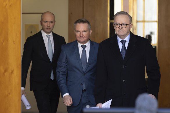 Matt Kean (left), Chris Bowen and Anthony Albanese arrive at a press conference on Monday.