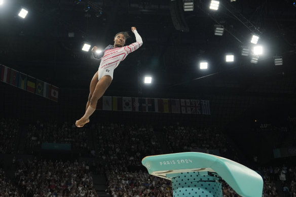 OK, maybe I couldn’t do THAT. Simone Biles performs on the vault in Paris.
