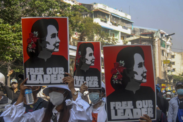 Protesters with pictures of deposed Myanmar leader Aung San Suu Kyi in Yangon in the aftermath of the 2021 coup.