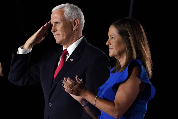 US Vice-President Mike Pence salutes on stage with his wife Karen after speaking on the third day of the Republican National Convention in Baltimore.