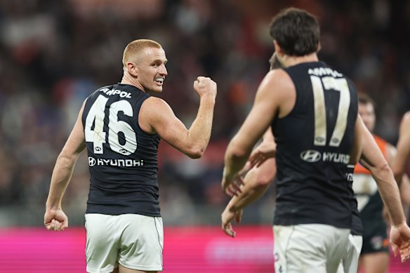 Matthew Cottrell celebrates a Carlton goal and later celebrates with a harmonica session.