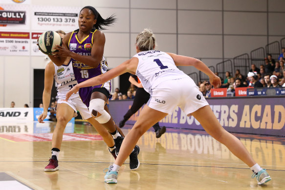 Lindsay Allen of the Boomers dribbles under pressure from Lauren Nicholson of the Lightning.
