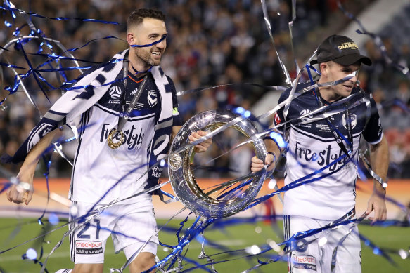 Broxham (right) with Victory captain Carl Valeri after winning the 2018 grand final.