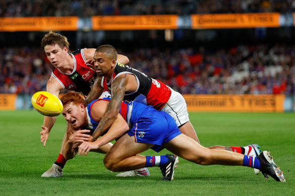 Mattaes Phillipou and Brad Hill exemplify St Kilda’s intensity with a gang-tackle on Ed Richards.