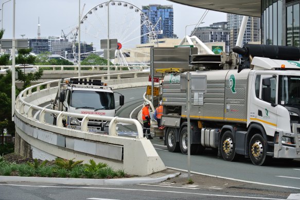 Garden debris from the Queen’s Wharf precinct washed into drains along the Margaret Street off-ramp, forcing road closures.