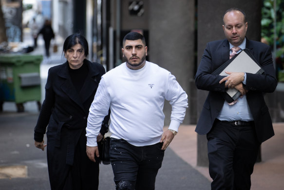 Jesse Marrogi (middle) and his mother Madlin Enwiya (left) arriving at the Melbourne Magistrates Court on Wednesday.