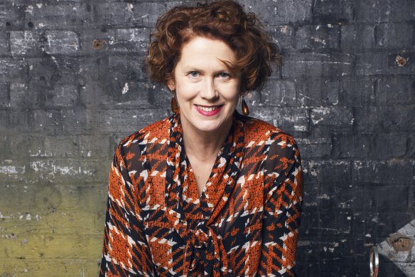 In her signature tartan, a self brand that began as a joke in Birmingham. She still has a pair of Doc Martens