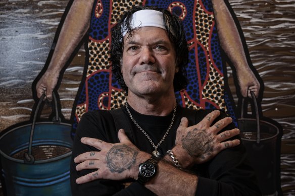 Blak Douglas in front of his winning Archibald portrait, Moby Dickens.