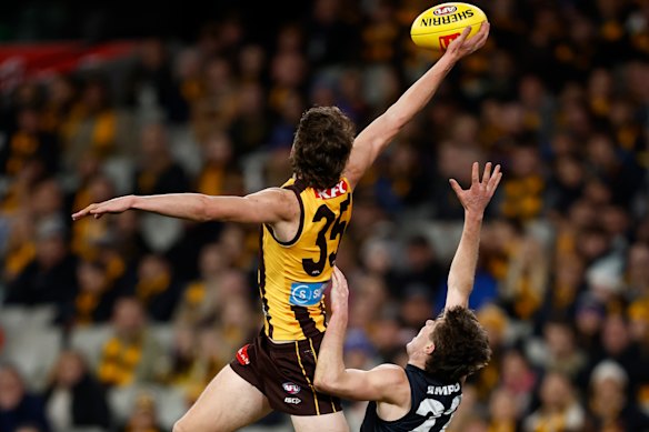 Hawthorn’s Calsher Dear takes a spectacular mark over Carlton’s Harry O’Farrell.