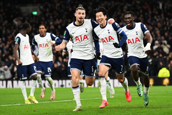 Son Heung-Min of Tottenham Hotspur celebrates with teammate Radu Dragusin after scoring his team’s fourth goal.