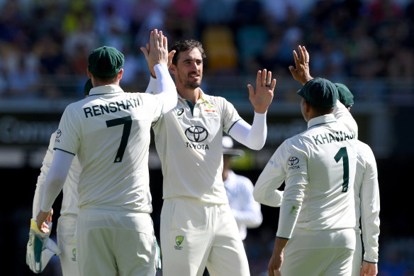 Mitchell Starc celebrates taking the wicket of Tagenarine Chanderpaul on day one of the Gabba Test.