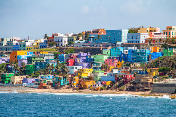 Colourful houses line the hillside overlooking the beach in San Juan, Puerto Rico. 