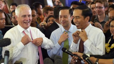 Informal: Malcolm Turnbull and Joko Widodo take off their ties during a visit to Tanah Abang market in Jakarta in November 2015.
