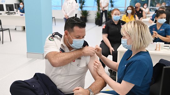 Ben Shepherd from the NSW Rural Fire Service receives his COVID-19 vaccine at the Olympic Park Vaccination Centre.