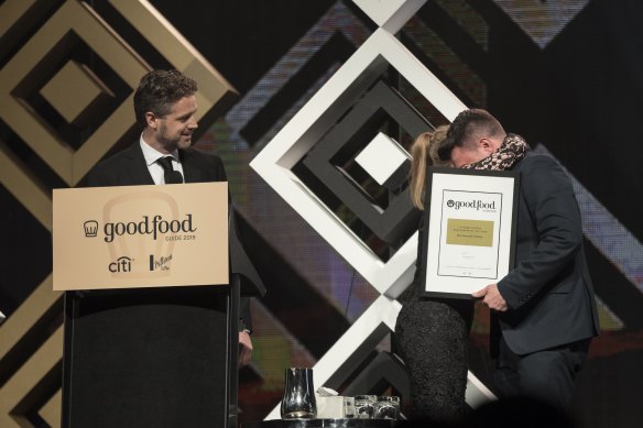 Jock Zonfrillo and Greta Wohlstadt receive their award for Restaurant of the Year at the 2019 Good Food Guide Awards