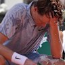 Jannik Sinner tries to cool himself down during a break.