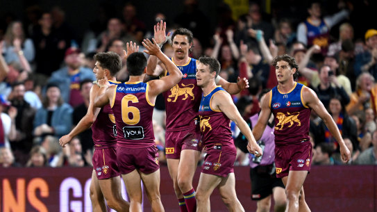 Joe Daniher and the Lions celebrate a goal.