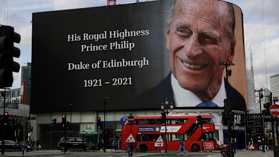 A tribute is projected onto a large screen at Piccadilly Circus in London.