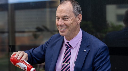 Jeff Pope serves The Age democracy sausages at AEC hq in Melbourne.