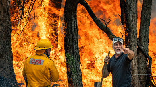 A CFA crew help Attila Hegedus defend his property at Raglan.