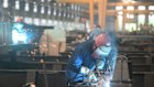 A worker in a steel structure factory in Hangzhou City. Factory activity has slowed. 