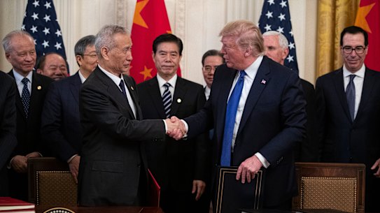 President Donald Trump and Chinese Vice Premier Liu He shake hands after signing the US-China trade agreement in the White House.