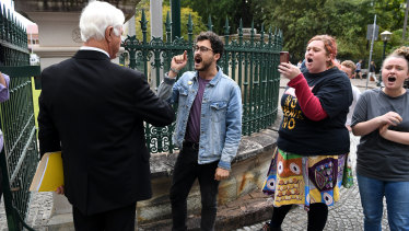 KAP federal leader Bob Katter confronts Socialist Alternative protesters at the gates of Parliament House in Brisbane.