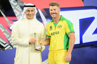 David Warner receives his Player Of The Tournament award the 2021 ICC T20 World Cup final.