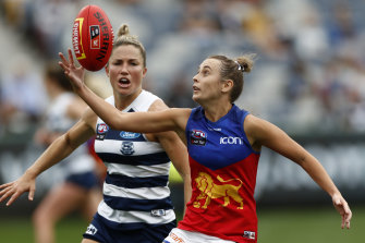 Gabby Collingwood of the Lions gathers the ball in front of Melissa Hickey of Geelong in the AFLW.