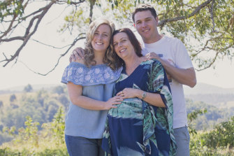 Surrogate Leonie McKinnon (centre) pregnant in 2017, with intended parents Rebecca MacDonald and Brodie Ashby.