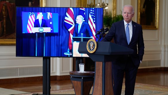 President Joe Biden, joined virtually by Australian Prime Minister Scott Morrison, right on screen, and British Prime Minister Boris Johnson, speaks about a national security initiative from the East Room of the White House.