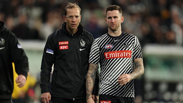 Jeremy Howe (right), with Collingwood football boss Charlie Gardner, was injured on Friday night.