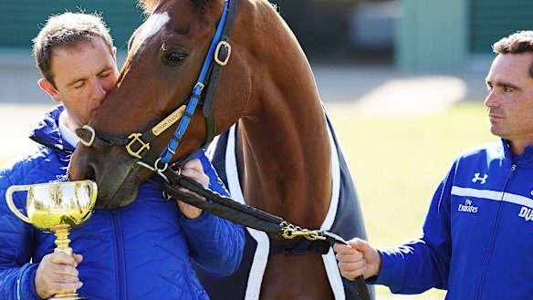 The day after: Charlie Appleby (left) and strapper Tash Eaton of team Godolphin pose with Cross Counter.
