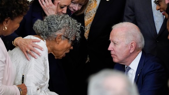 US President Joe Biden listens to 94-year-old activist Opal Lee after signing the Jbill. 