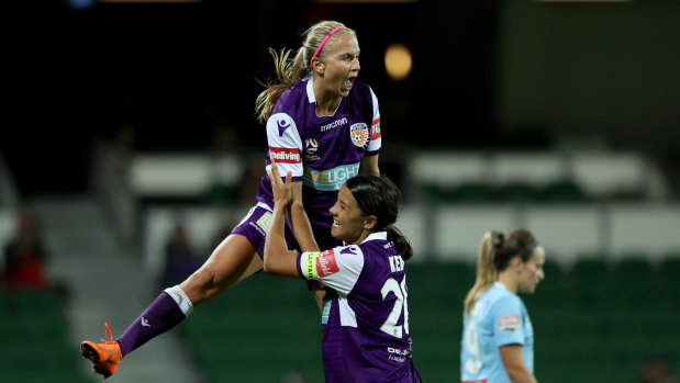 High-flyers: Alyssa Mautz (left) and Sam Kerr celebrate in Perth's 5-2 romp against Melbourne City.