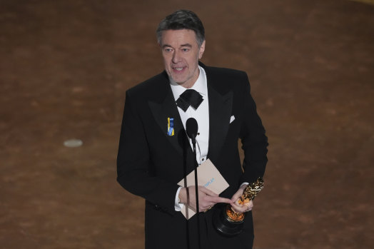 Peter Straughan accepts the award for best adapted screenplay for Conclave.