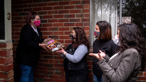 Eltham resident Jess Hoyle gets a care pack from Bec Russell, Jennifer Niehues, Patricia Callinan.