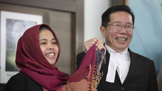 Siti Aisyah, left, smiles with her lawyer Gooi Soon Seng at a press conference after she was freed from custody.