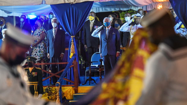 Prince Charles watches as the British royal standard is folded after it is lowered in Bridgetown, Barbados, on Tuesday.