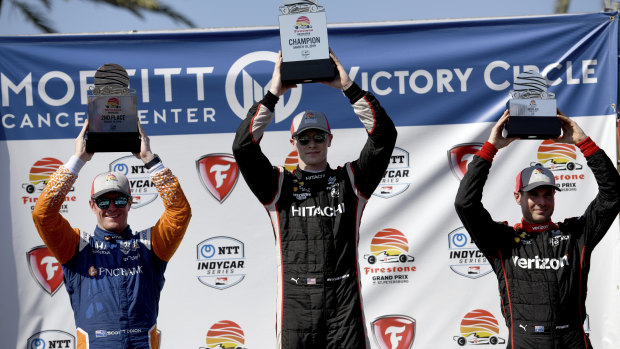 Josef Newgarden (centre), celebrates his IndyCar victory with teammate Will Power (right) and second-placed Scott Dixon (left).