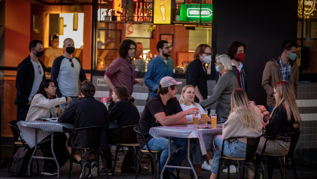 Outdoor dining in Melbourne's east on Wednesday night. Groups of customers are limited to 10 people and must be seated 1.5 metres from other tables.