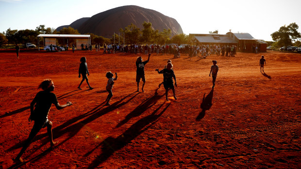 Children play footy at the Mutitjulu community during First Nations National Convention in 2017. 