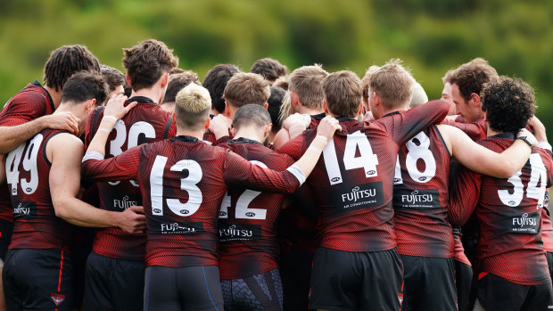 Essendon players form a huddle at training on Wednesday.