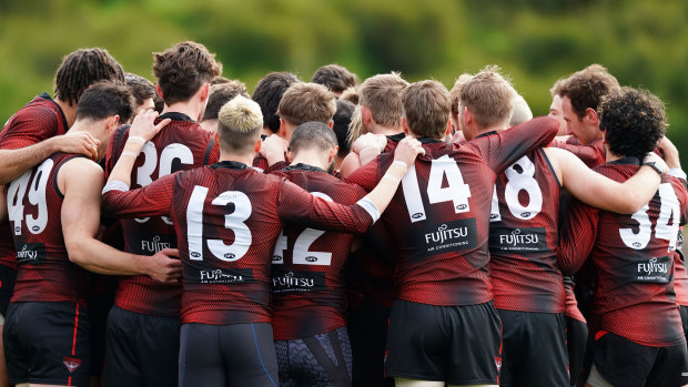 Essendon players form a huddle at training on Wednesday.
