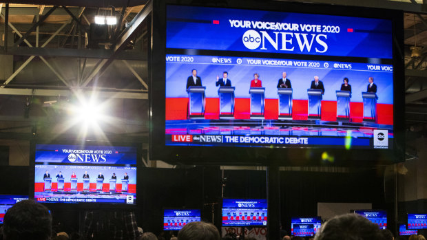 2020 Democratic presidential candidates are seen on television screens in the spin room during the Democratic presidential debate at Saint Anselm College in Manchester, New Hampshire.