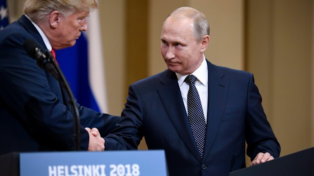 US President Donald Trump and Russian President Vladimir Putin shake hands in Helsinki, Finland, on July 11.