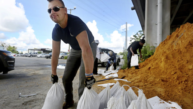 Kevin Orth loads sandbags into cars as he helps residents prepare for Hurricane Florence, in Charleston, South Carolina.