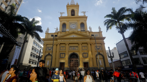 People walk outside the Metropolitan Cathedral after the fatal shooting in Campinas, Brazil.