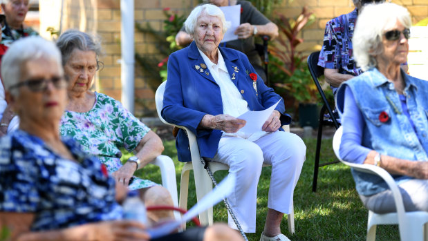 Thelma Hughes, 96, (centre) sits with fellow widows during a small Anzac Day ceremony in Brisbane.