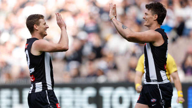 Will Hoskin-Elliott celebrates a goal with teammate Brody Mihocek during the Pies’ clash with Port Adelaide.